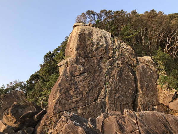 Iwakura towering as a huge wall rock